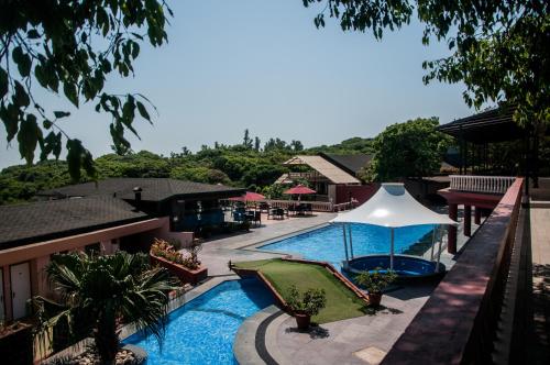 a view of a swimming pool at a resort at Brightland Resort & Spa in Mahabaleshwar