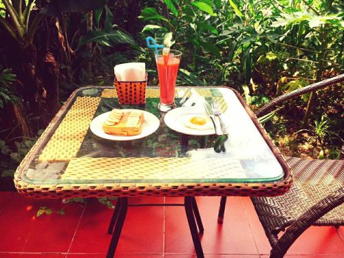 a table with a plate of food and drinks on it at Van Long Family Homestay in Ninh Binh