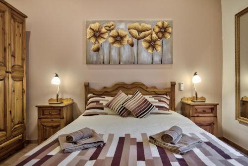 a bedroom with a bed with towels on it at Valletta Apartments 19 in Valletta