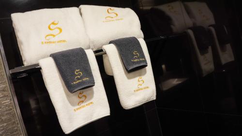 a group of towels with s dollar signs on them at S Hadyai Hotel in Hat Yai