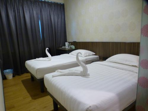 Кровать или кровати в номере Hotel 138 @ Bestari