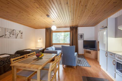 a kitchen and living room with a table and a couch at Poukama in Porvoo