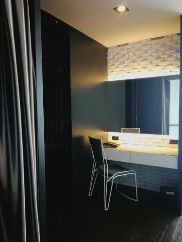 a chair sitting at a desk in a kitchen at S Hadyai Hotel in Hat Yai