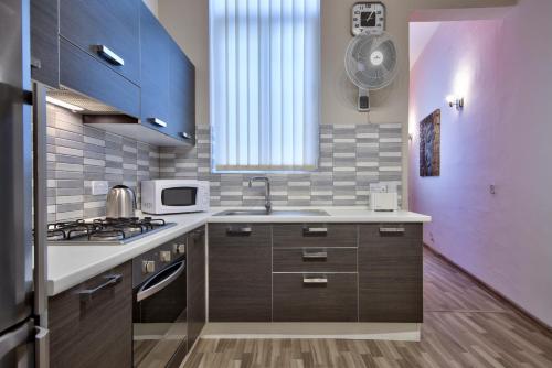 a kitchen with a sink and a stove top oven at Valletta Apartments 19 in Valletta