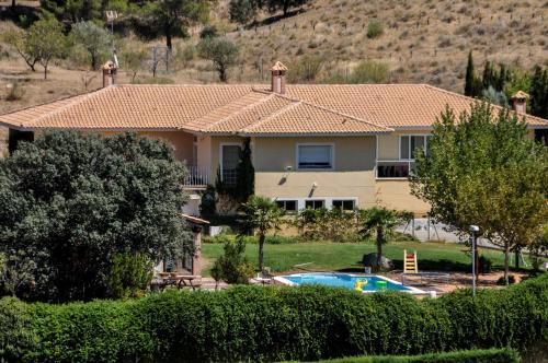 a house with a swimming pool in front of it at Chalet San Bernardo in Toledo