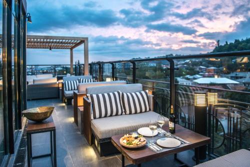a patio with a table and chairs on a balcony at Best Western Kutaisi City Center in Kutaisi