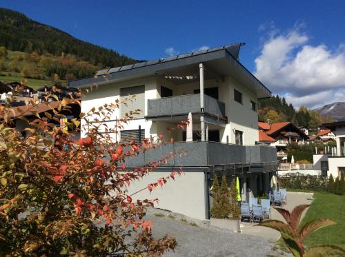 a white house with a balcony on top of it at Haus Hannah in Ladis