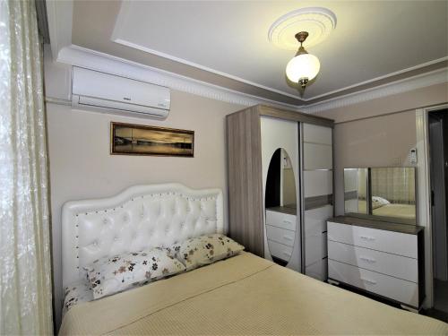 a bedroom with a white bed and a mirror at Sultanahmet Deluxe Yilmaz Apart in Istanbul