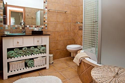 a bathroom with a toilet and a sink and a shower at Nahariya Beachfront in Nahariyya