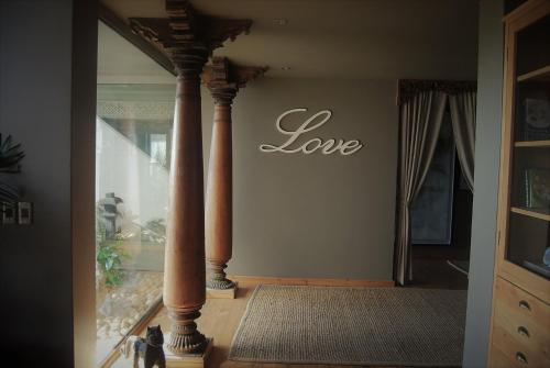 a room with columns and a sign that reads love at Forest Nature Spa in The Crags