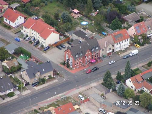 an aerial view of a town with houses and a street at Pension Kuehnauer Hof in Dessau