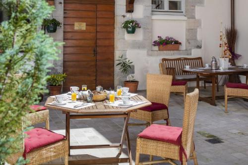 a table and chairs on a patio at Appart Hotel Charles Sander in Salins-les-Bains