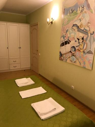 a room with mats on the floor and a painting on the wall at New House in Petergof