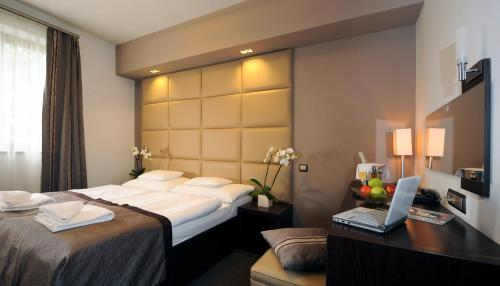 Кровать или кровати в номере Hotel Villa Völgy Wellness & Konferencia