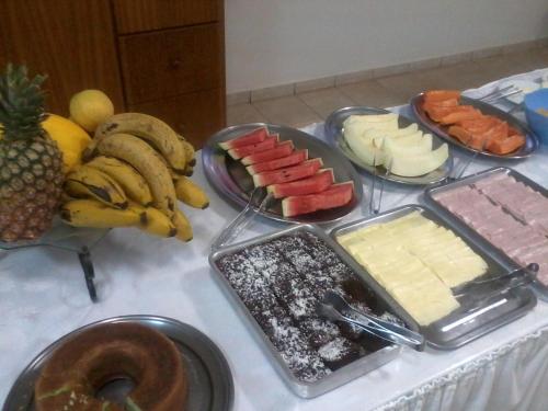 a table topped with different types of cheese and fruit at Sevilha Park Hotel in Colorado