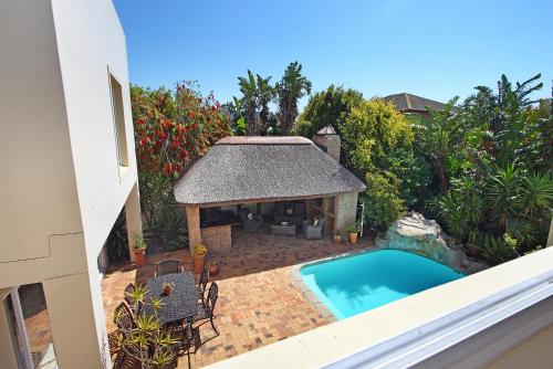 an overhead view of a swimming pool with a gazebo at Atlantic Breeze in Cape Town