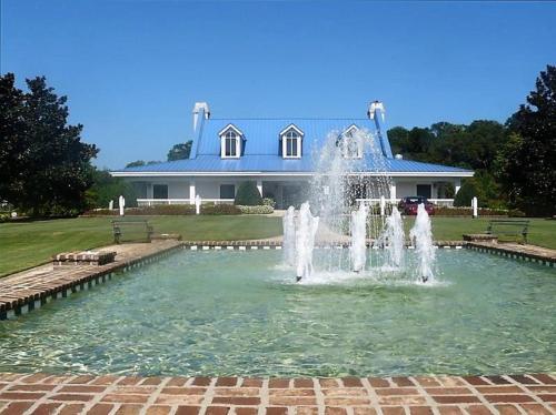 a water fountain in front of a house at Pawleys Island Vacation Rentals llc in True Blue