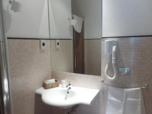 a bathroom with a sink and a mirror at Hotel Diecimare in Cava deʼ Tirreni
