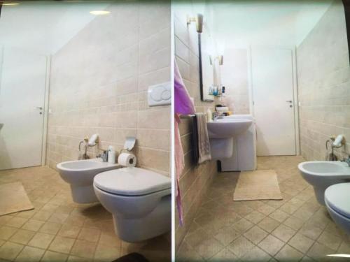 a bathroom with two toilets and two sinks at Casa con giardino in Cervia