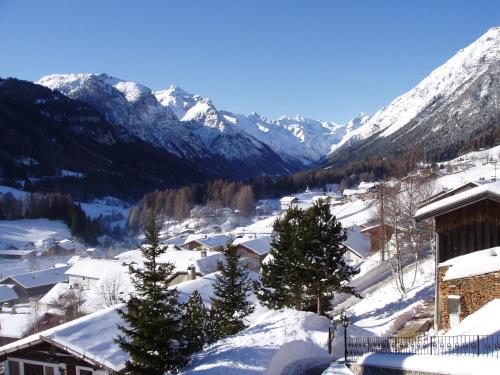 a village covered in snow with mountains in the background at Haus Sonnleite in Trins
