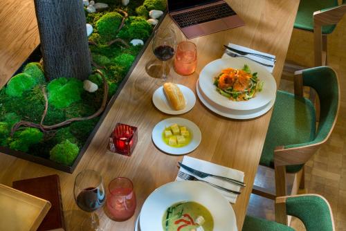 a wooden table with plates of food on it at Hotel Mirador de Chamartín in Madrid