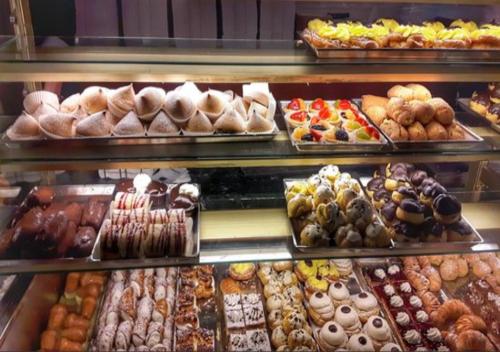 a display case filled with lots of different types of pastries at La casa del nonno in Matera