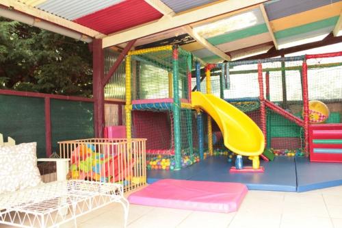 a colorful playground with a slide at Emerald Coast Gites and Lodge in Hénansal
