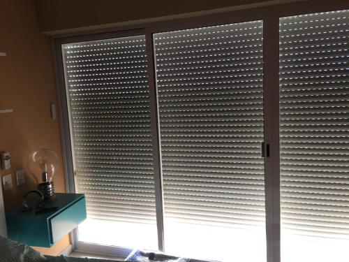 a window with blinds on it in a room at Playa y alberca en Zona Marina in Mazatlán