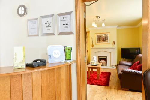 a room with a reception desk and a living room at Brooke Lodge Guesthouse in Magherafelt