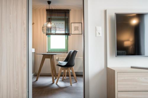 a dining room with a table and a chair at stattHotel Weimar in Weimar