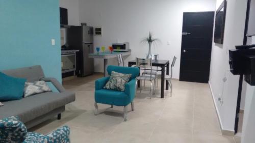 a living room with a couch and chairs and a table at Departamento en Dream Lagoons Cancun in Cancún