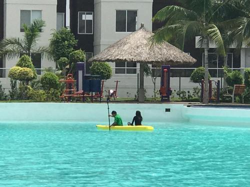 two people sitting on a paddle board in the water at Departamento en Dream Lagoons Cancun in Cancún