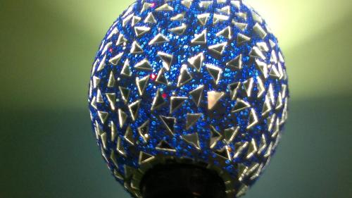 a blue and white glass ball with many diamonds at Ray of Maya in Agra