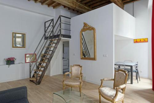 Habitación con escalera, sillas y mesa. en L'Argenterie, Apparts de charme, parking gratuit, en Montpellier