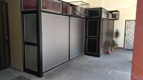 a room with a large white door with a balcony at Apart Office in San Miguel de Tucumán