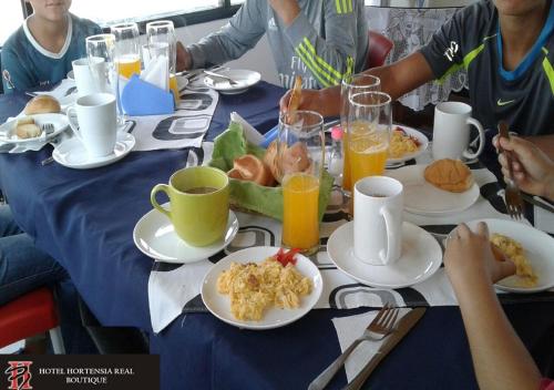 a group of people sitting at a table eating breakfast at Hotel Hortensia Real in Paipa