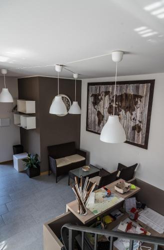 a living room with two pendant lights and a couch at AcquaTerraFuoco - City apartments in Como