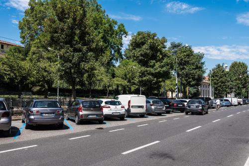 a line of cars parked on the side of a road at AcquaTerraFuoco - City apartments in Como