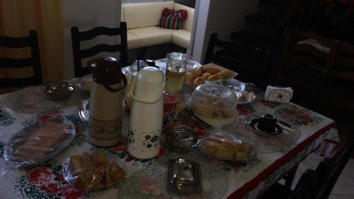 a table with a table cloth with food on it at Suítes da Erô in Arraial do Cabo