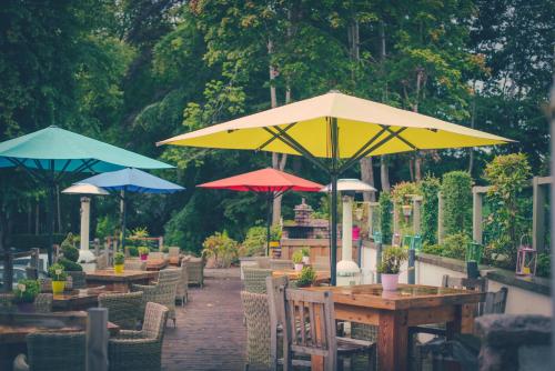 a row of tables with umbrellas on a patio at Banchory Lodge Hotel in Banchory