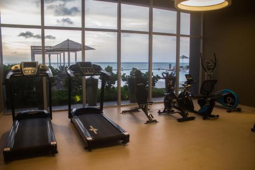 a gym with cardio equipment in front of a large window at Namaste Alojamientos Luxury Cartagena in Cartagena de Indias