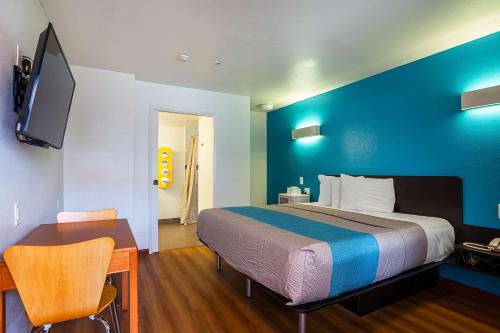 a bedroom with a large bed with a blue wall at Motel 6-Ventura, CA - Downtown in Ventura