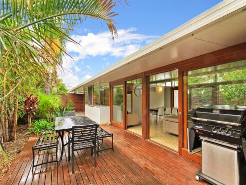 a house with a wooden deck with a piano at Perla del Mare in Aldinga Beach