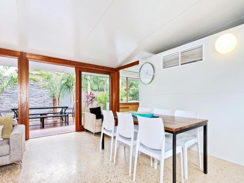 a dining room with a table and chairs at Perla del Mare - Aldinga Beach - C21 SouthCoast Holidays in Aldinga Beach