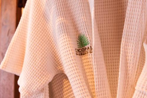 a white towel with a pineapple on it at Coco Palm Beach Resort - SHA Extra Plus in Mae Nam
