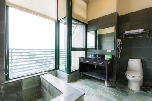 a bathroom with a sink and a toilet at L Hotspring B&B in Jiaoxi