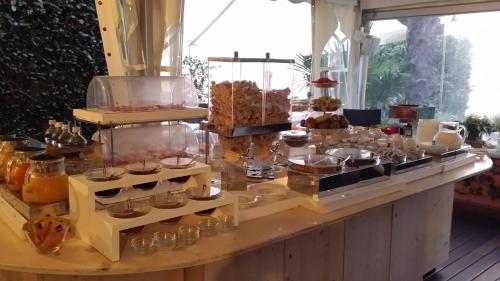 a buffet with many different types of desserts on display at Relais Villa Margherita in Oggebbio