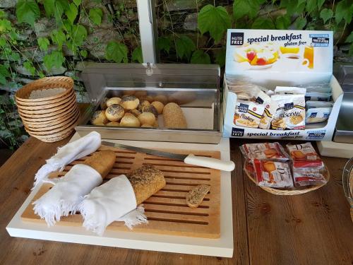a tray with hot dogs and other food on a table at Relais Villa Margherita in Oggebbio