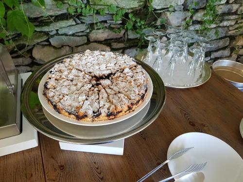 a cake sitting on top of a wooden table at Relais Villa Margherita in Oggebbio
