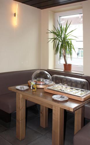 a wooden table with plates of food on it at Südhotel in Paderborn